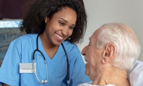 Medical Assistant Smiling with Elderly Patient