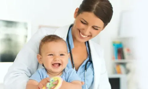 Pediatric Nurse Practitioner Smiling with Infant Patient