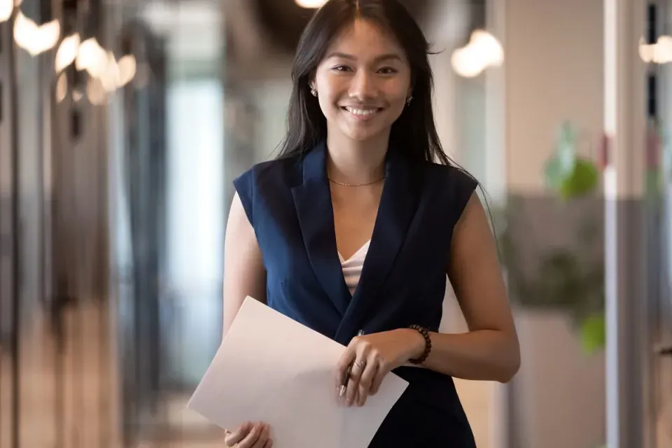 Human Resources HR Manager Smiling with Notes for Meeting